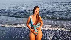 Horny teen shows off her big ass on the public beach, getting her pussy exposed outdoors