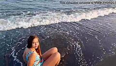 Horny teen shows off her big ass on the public beach, getting her pussy exposed outdoors