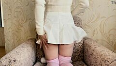 Watch this girl in a white skirt pleasure herself with a vibrator!