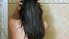 Beautiful brunette model washing up in the shower