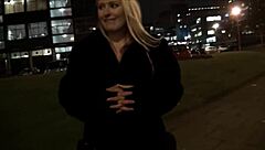 Blonde European beauty flaunts assets in downtown setting