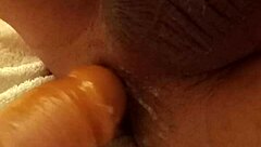 A girl uses a dildo to have sex with a man and gives him pleasure until he cums