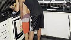 Young guy interacts with big black guy while making coffee