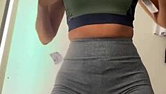 Hot brunette wife tries on clothes in shopping mall
