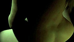 Beautiful curvy plum girl rides dildo in the dark, showing big tits and cute face.