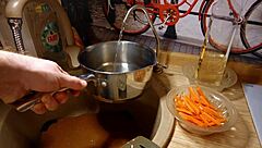 Naked gay chef cooks rice noodle with chicken and vegetables