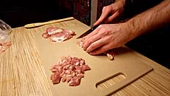 Naked gay chef cooks rice noodle with chicken and vegetables