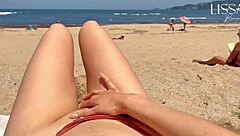 A man I don’t know gives me a blow job on a public beach