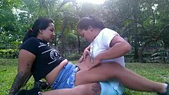 Hot lesbians kiss and caress outdoors in public park