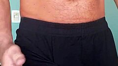 Bodybuilder's shorts highlight his bulge in muscle attire