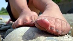 Goddess In Tan Nylons Shows Cute Nylon Soles And Toes On The Riverside