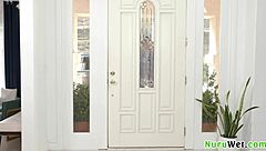 gorgeous blonde masseuse applies nuru gel and chats with client