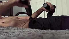 a solo male bodybuilder massages his pelvis for therapeutic release during workout