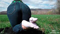 Cute toes in white socks on a spring grass field