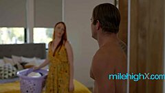 Redhead stepmother seduces her stepson and fucks him on the stairs
