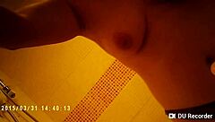 Spy camera footage of a naked girl in the shower with big tits