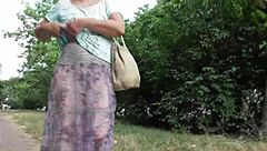 A hot mature woman with hairy pussy in a transparent dress