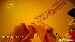 Spy camera footage of a naked girl in the shower with big tits