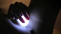 Petite teen 18+ rubs trimmed pussy with light at night.