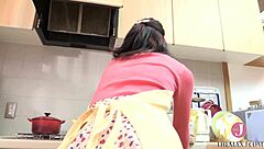 kitchen babe licks candy with naughty look