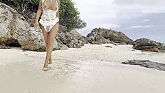 Fox appeals, naked, on the white sand beach