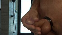 A guy with small dick plays with it, covered with oil