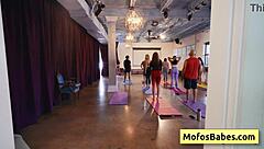 blonde busty woman stretches during yoga class