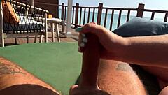 Stunning brunette gives amazing handjob on the terrace
