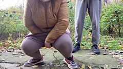 curvy milf squats in leggings outdoors