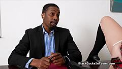 The black man has his way with a girl on the teacher's desk