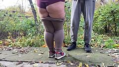 curvy milf squats in leggings outdoors