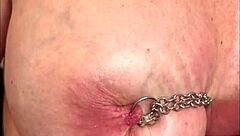 Hard play with pierced nipples by chain bondage