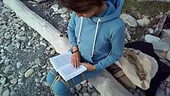 Sofi feels relaxed reading her book by the sea in POV