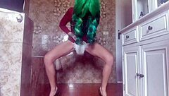A cute, playful girl in a diaper, peeing unexpectedly