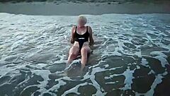 The blonde bares her tits on the beach and makes a blowjob