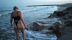 The blonde bares her tits on the beach and makes a blowjob