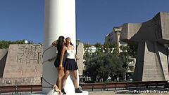 A red-haired girl is having fun with her girlfriend in public place