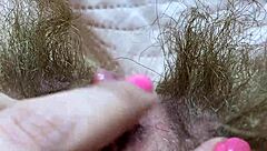 A girl achieves orgasm by rubbing her huge clitoris