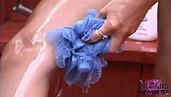 This hot brunette is shaving her asshole in an outdoor shower, looking tanned and smooth