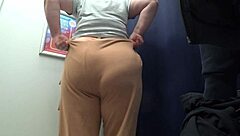 Camera Catches Curvy MILF Changing Clothes in Fitting Room, Revealing Big Ass in Satin Panties