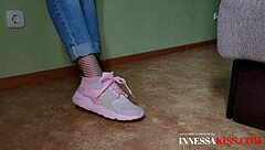 the housewife in fishnets and stockings shows her cute heels to the camera while posing