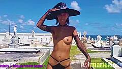 why is this goth slut in bunny costume dancing topless in public cemetery, showing small waist and armpits?