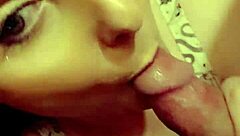 A redhead milf is sucking on a hard cock in a casual setting.