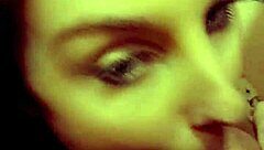 A redhead milf is sucking on a hard cock in a casual setting.