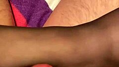 Giving the hubby a footjob in black reinforced toe stockings