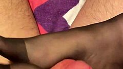 Giving the hubby a footjob in black reinforced toe stockings