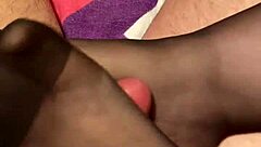 Giving the hubby a footjob in black reinforced toe stockings