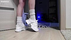 In the shower, a British teen babe showcases her delicate legs and feet in sneakers for fetish lovers.