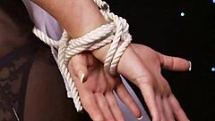 two big-tits lesbians rub together in bondage lingerie.