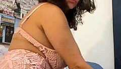 anna maria the mature latina strips pink lingerie teasing her big tits and ass in part ii, revealing caribbean dominican curves slowly.